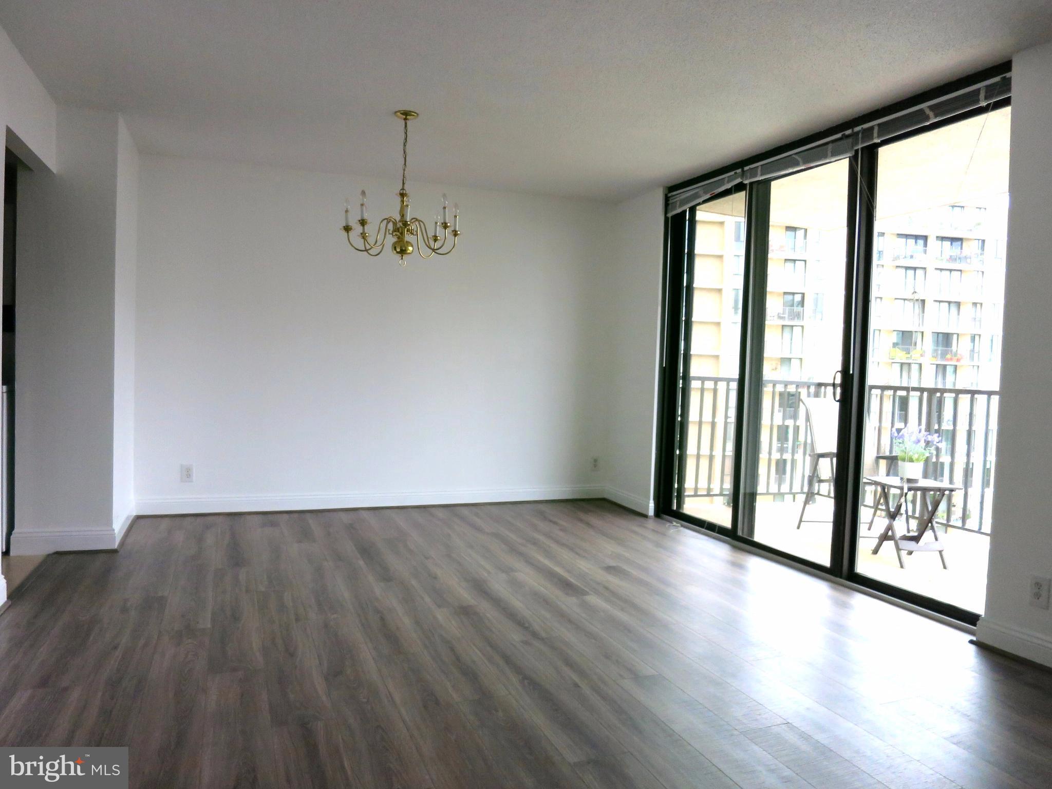 6800 Fleetwood Road, Unit 716 McLean, VA 22101 - Photo 3 of 17 a view of an empty room with wooden floor and a window