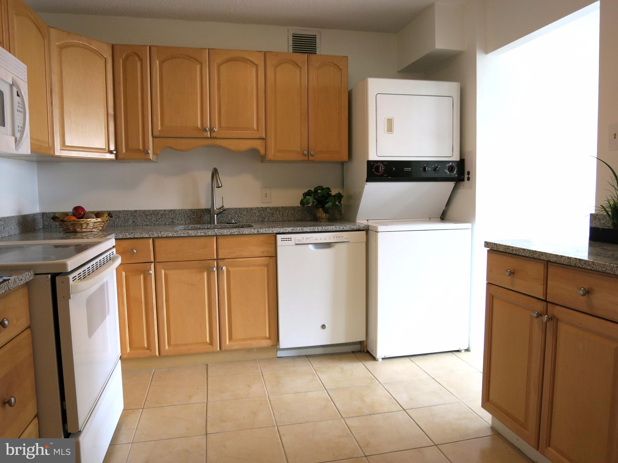6800 Fleetwood Road, Unit 716 McLean, VA 22101 - Photo 6 of 17 a kitchen with a sink a stove and cabinets