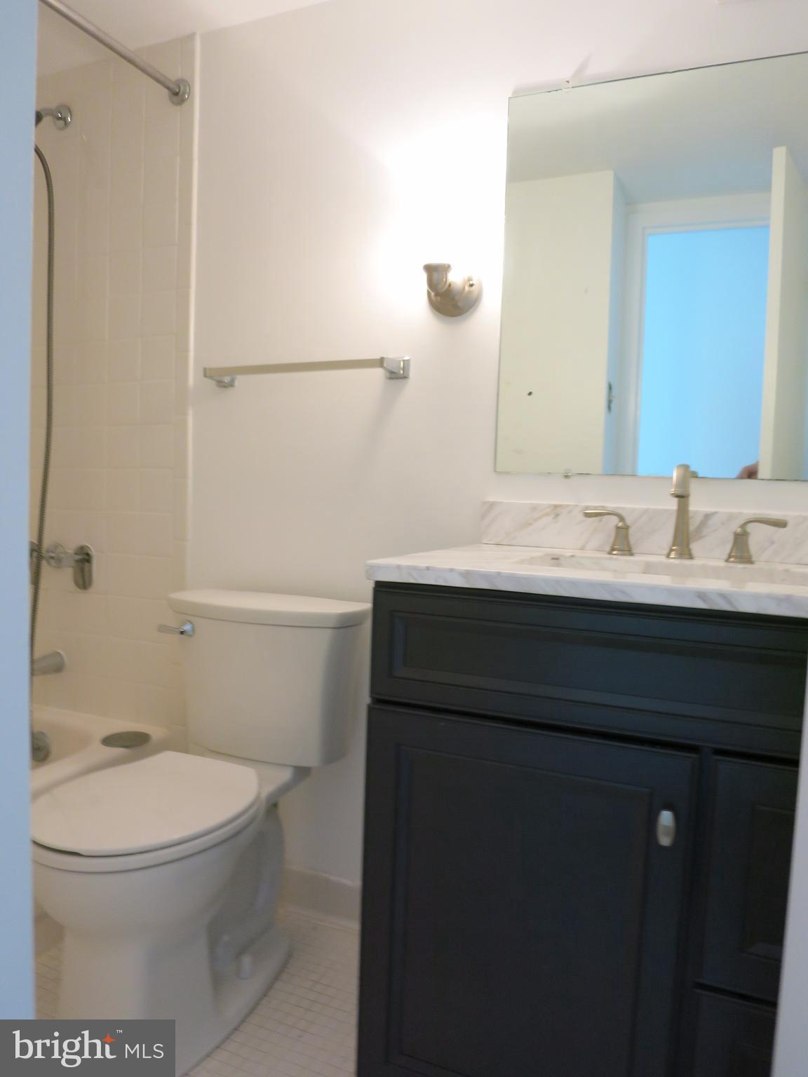 6800 Fleetwood Road, Unit 716 McLean, VA 22101 - Photo 8 of 17 a bathroom with a sink a toilet and shower