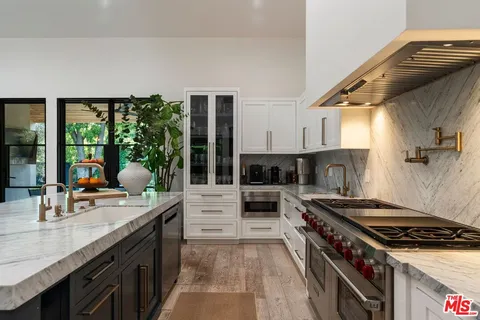 a kitchen with a stove and a sink