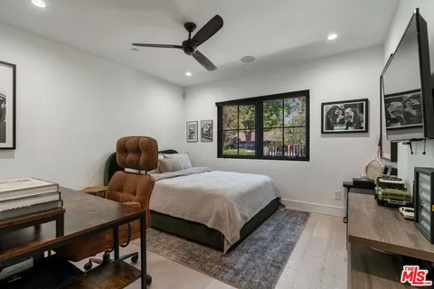 a bedroom with a bed a desk and chair
