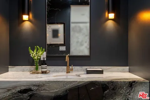 a bathroom with a sink a vanity and a mirror
