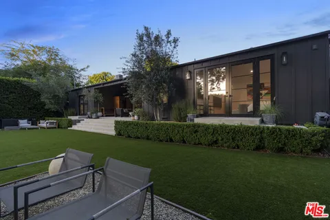 a view of a house with a yard porch and sitting area