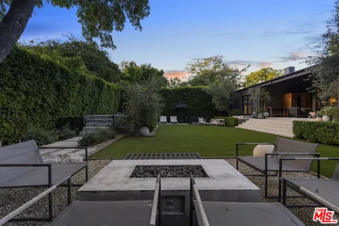a view of a patio with dining table and chairs with a yard