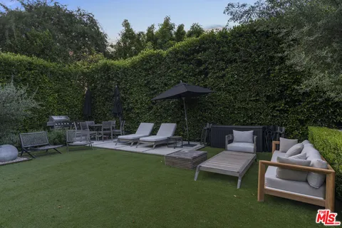 a view of backyard with seating area and green space