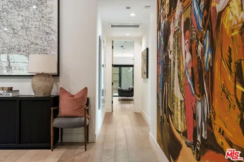 a hallway with a dining table and chairs