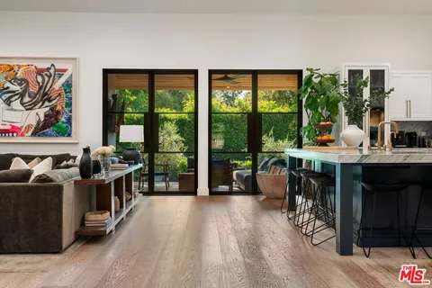 a living room with furniture and a floor to ceiling window