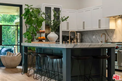 a kitchen with a table and chairs in it