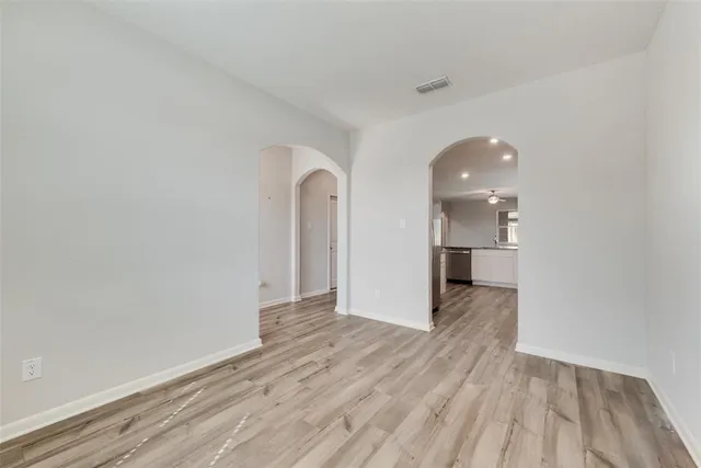 a view of a room with wooden floor and a sink