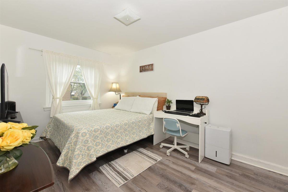 196-65 69th Avenue, Unit 1 Queens, NY 11365 - Photo 19 of 24 Bedroom featuring baseboards and wood finished floors