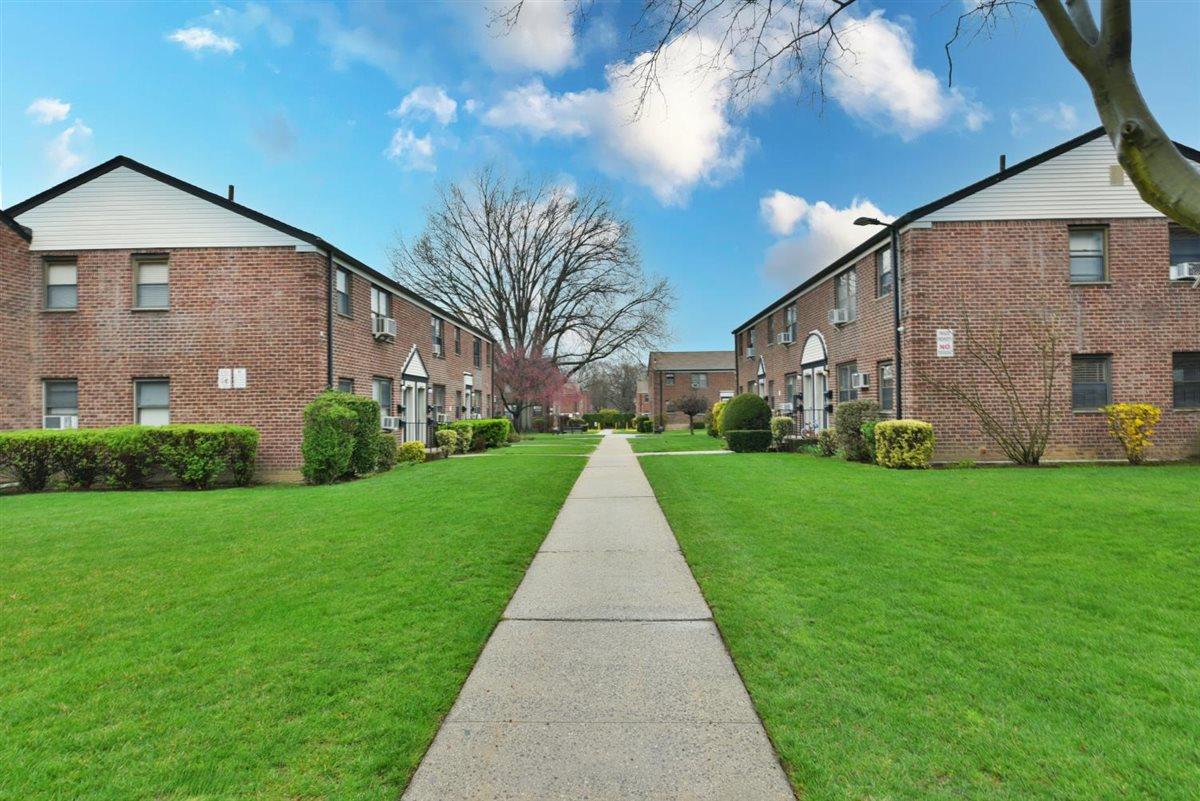 196-65 69th Avenue, Unit 1 Queens, NY 11365 - Photo 23 of 24 View of home's community featuring a yard and a residential view