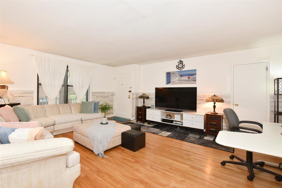 196-65 69th Avenue, Unit 1 Queens, NY 11365 - Photo 8 of 24 Living area featuring light wood-style flooring