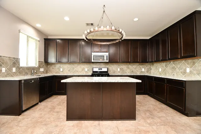 a kitchen with a sink and wooden cabinets