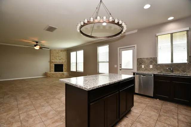 a kitchen with granite countertop cabinets a sink and stainless steel appliances