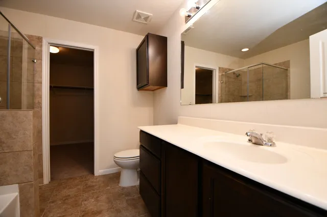 a bathroom with a sink a toilet and mirror
