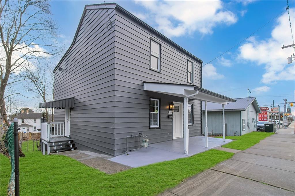 517 Adams Street Rochester, PA 15074 - Photo 1 of 21 a front view of a house with garden