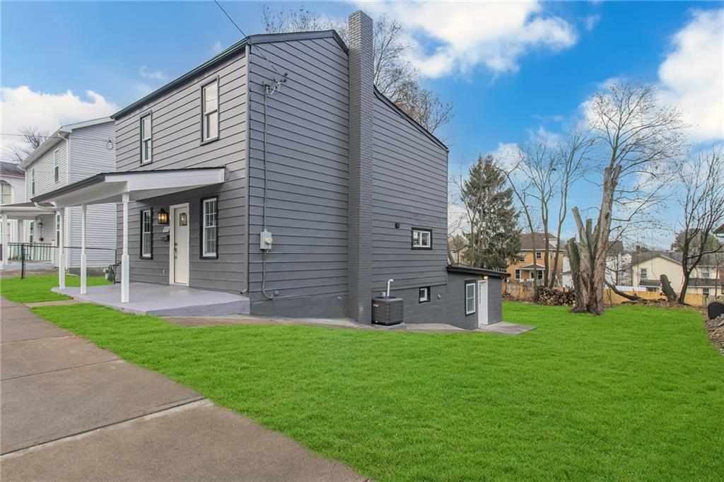 517 Adams Street Rochester, PA 15074 - Photo 2 of 21 a front view of a house with a garden and yard