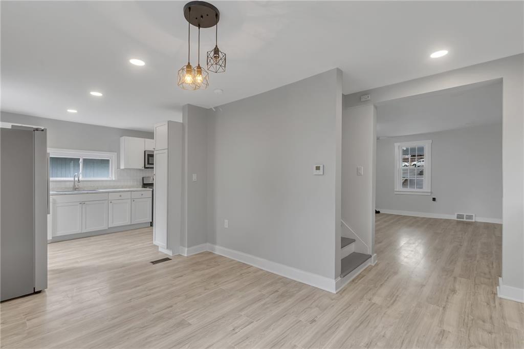 517 Adams Street Rochester, PA 15074 - Photo 8 of 21 a view of a kitchen with a sink refrigerator and wooden floor