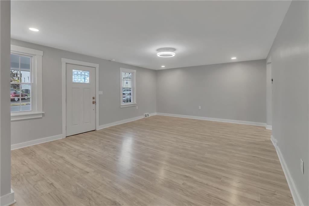 517 Adams Street Rochester, PA 15074 - Photo 10 of 21 an empty room with wooden floor and windows