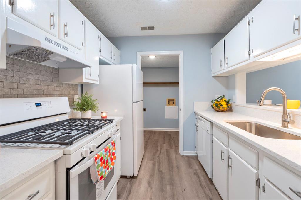 1213 Hanover Place Alpharetta, GA 30009 - Photo 11 of 25 a kitchen with a sink stove and cabinets