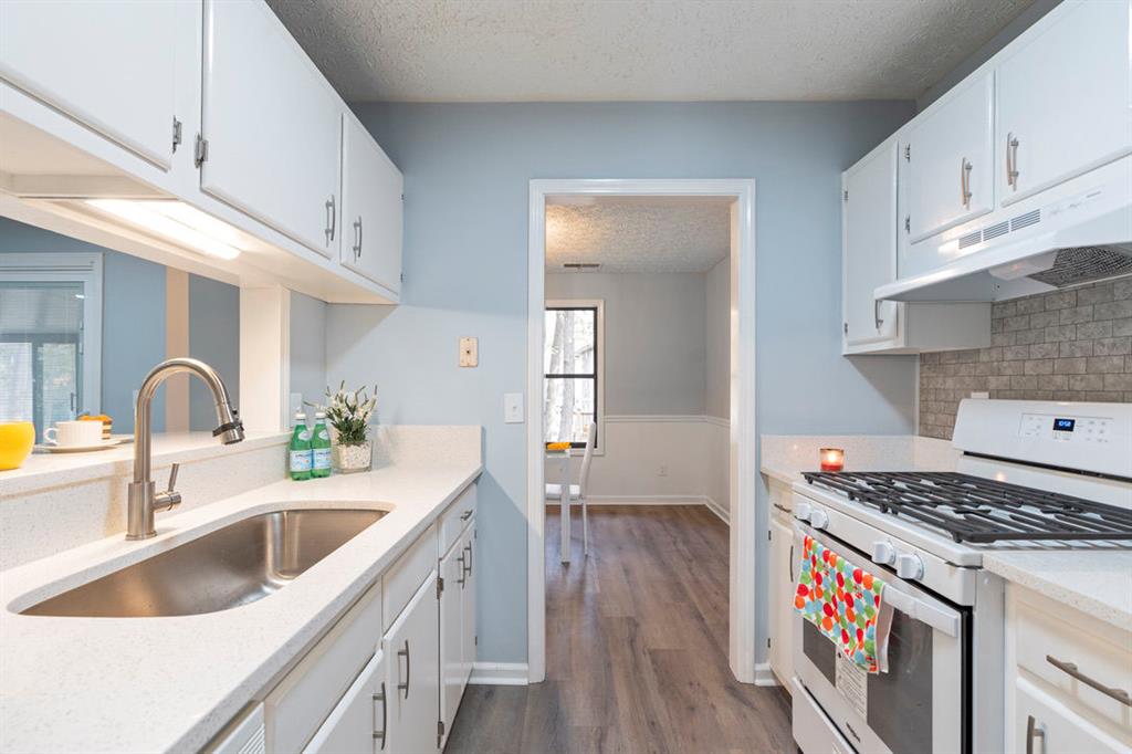 1213 Hanover Place Alpharetta, GA 30009 - Photo 12 of 25 a kitchen that has a sink and a stove
