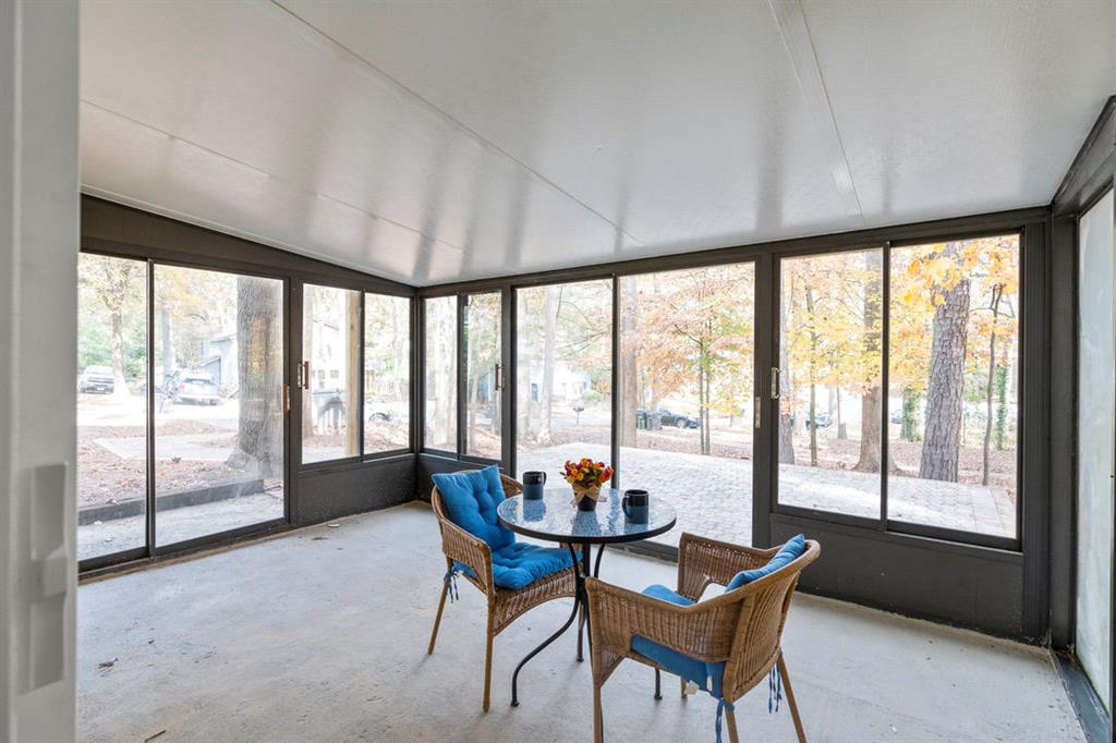 1213 Hanover Place Alpharetta, GA 30009 - Photo 14 of 25 a dining room with furniture a chandelier and glass door