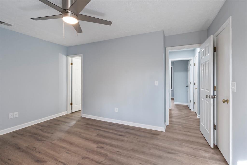 1213 Hanover Place Alpharetta, GA 30009 - Photo 17 of 25 wooden floor in an empty room with a fan