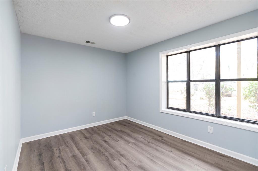 1213 Hanover Place Alpharetta, GA 30009 - Photo 19 of 25 an empty room with wooden floor and windows