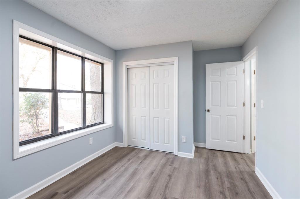 1213 Hanover Place Alpharetta, GA 30009 - Photo 20 of 25 an empty room with wooden floor and windows