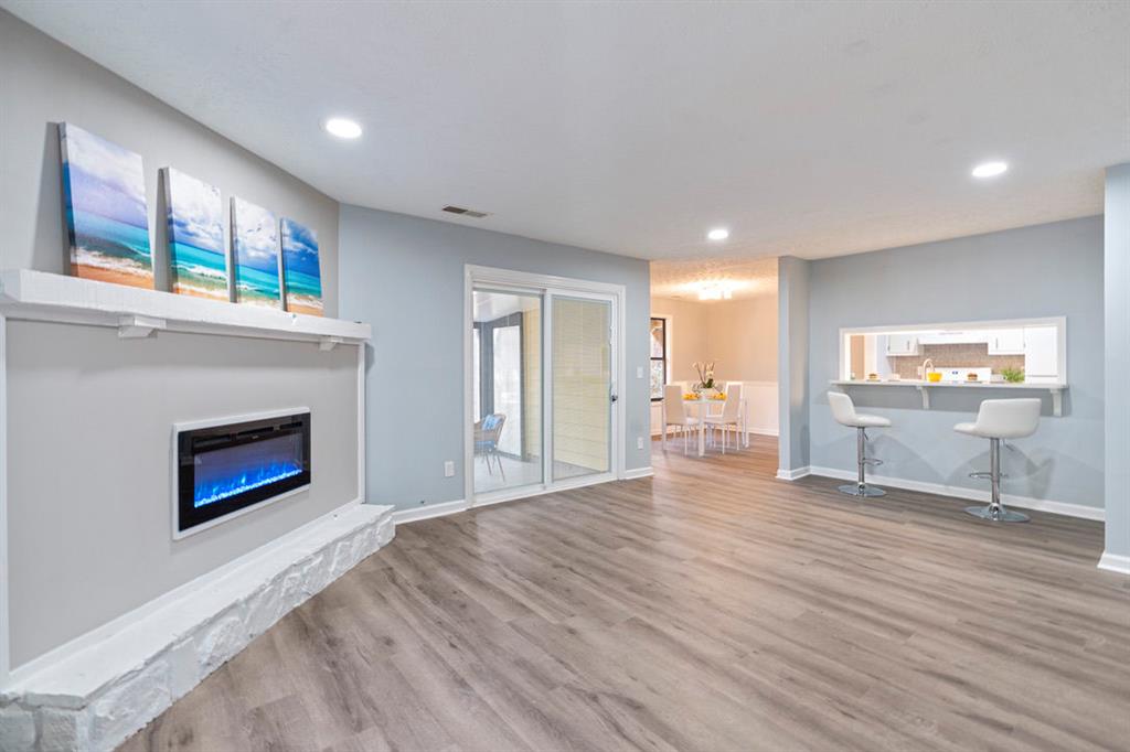 1213 Hanover Place Alpharetta, GA 30009 - Photo 5 of 25 a view of an empty room with a fireplace and a window