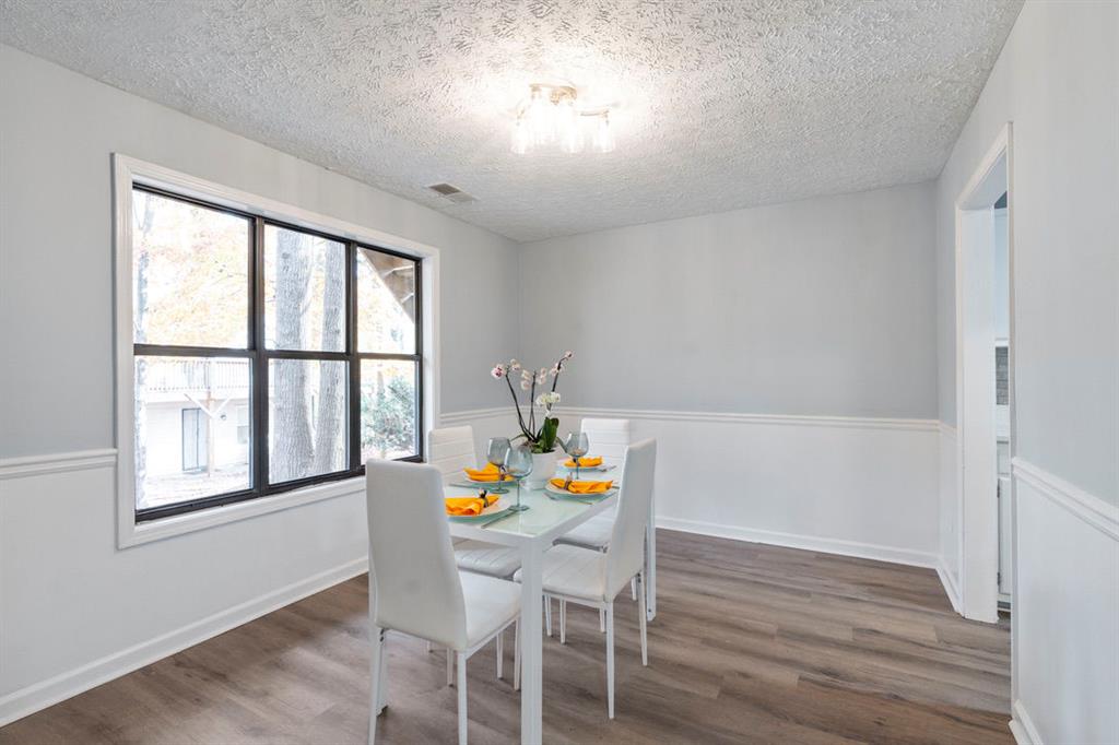 1213 Hanover Place Alpharetta, GA 30009 - Photo 8 of 25 a dining room with furniture a window and wooden floor