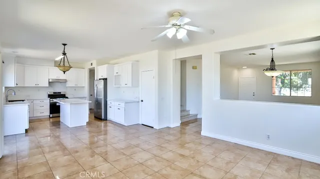 a view of a kitchen with a sink and cabinets
