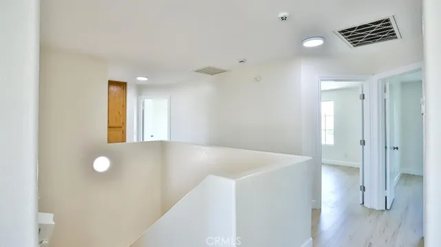 a view of an empty room and wooden floor