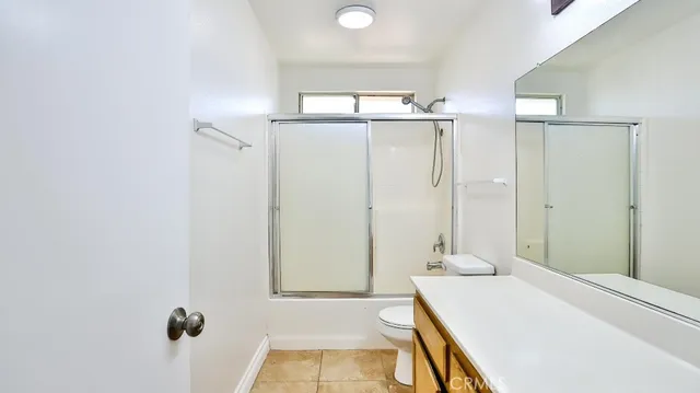 a bathroom with a sink a granite counter and a shower