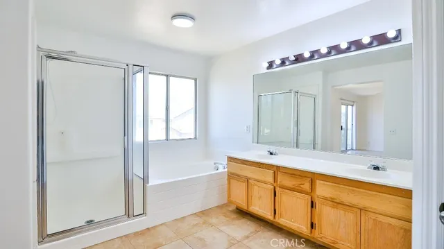 a bathroom with a tub a sink and a mirror