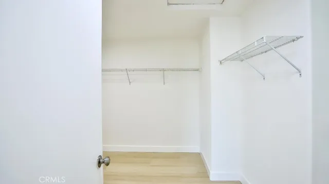 a view of walk in closet with empty racks