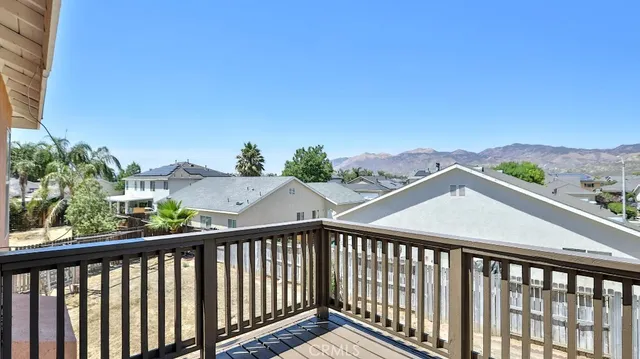 a view of a balcony with wooden fence