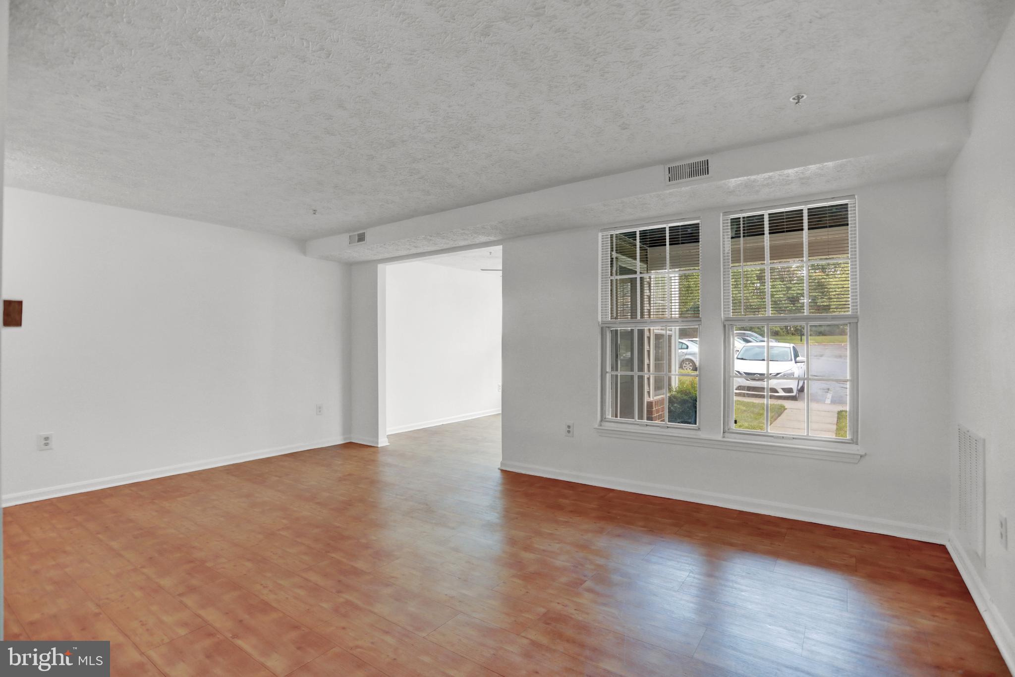 904 A Swallow Crest Court, Unit 904A Edgewood, MD 21040 - Photo 14 of 33 an empty room with wooden floor and windows