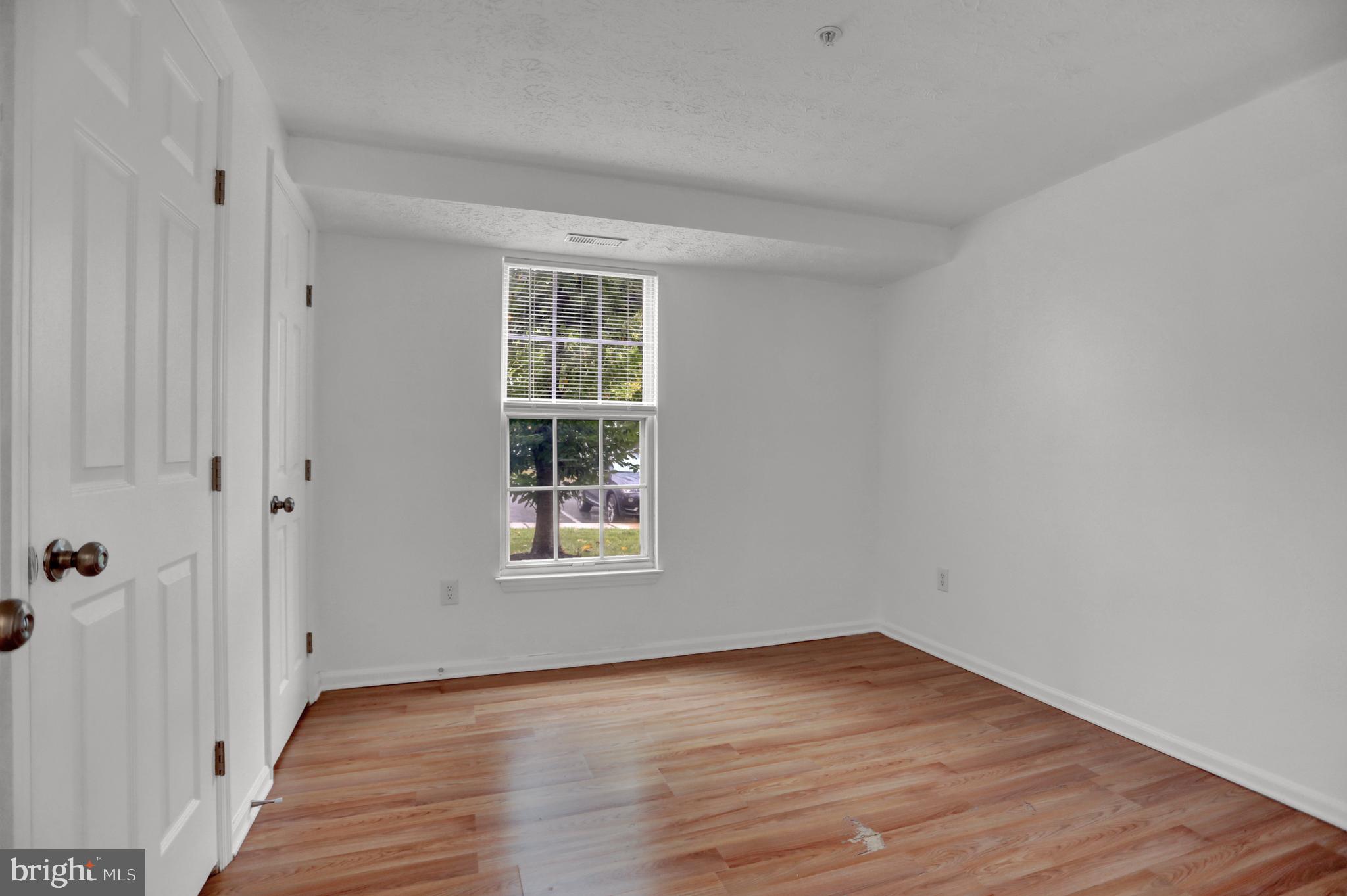 904 A Swallow Crest Court, Unit 904A Edgewood, MD 21040 - Photo 18 of 33 an empty room with wooden floor and windows