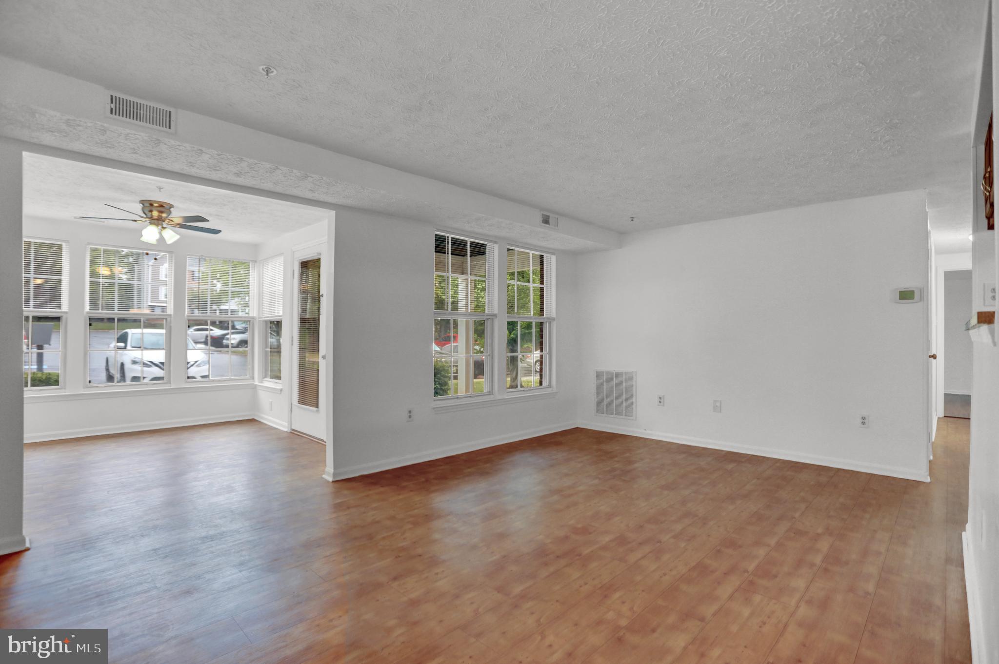 904 A Swallow Crest Court, Unit 904A Edgewood, MD 21040 - Photo 4 of 33 a view of an empty room with wooden floor and a fireplace