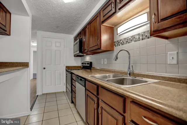 a kitchen with stainless steel appliances granite countertop a stove and a microwave