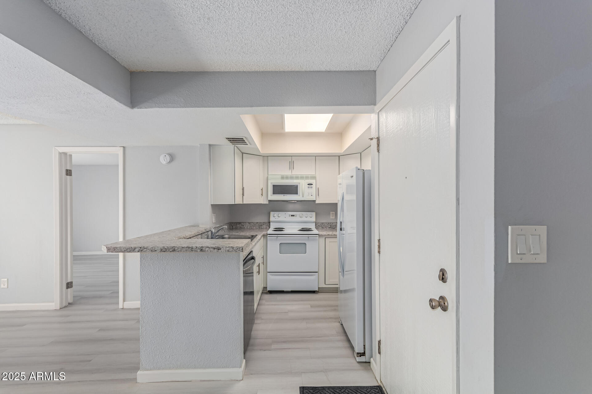 4730 West Northern Avenue, Unit 1087 Glendale, AZ 85301 - Photo 11 of 34 a kitchen with stainless steel appliances granite countertop a stove and a refrigerator