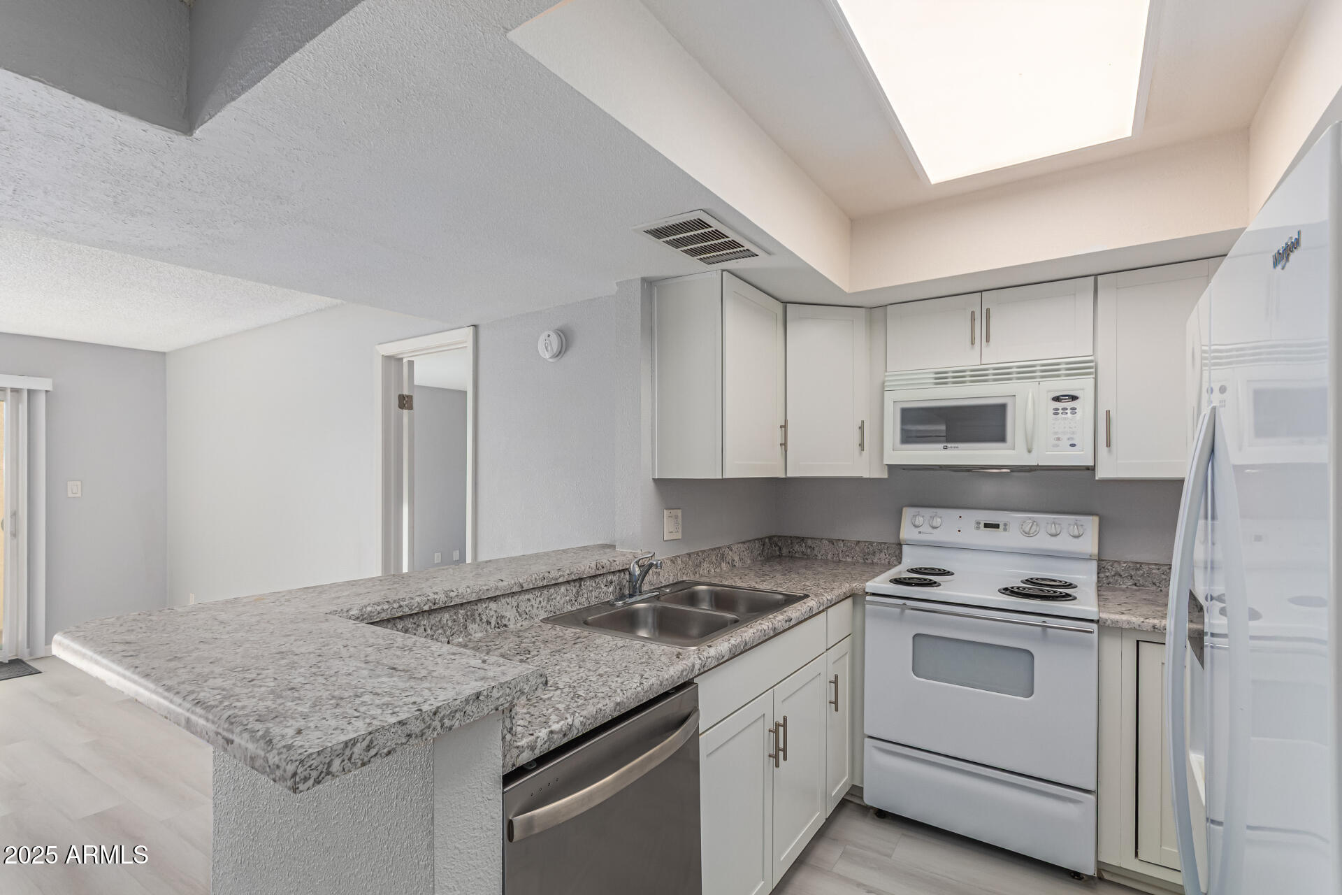 4730 West Northern Avenue, Unit 1087 Glendale, AZ 85301 - Photo 12 of 34 a kitchen with granite countertop cabinets stainless steel appliances and a counter space