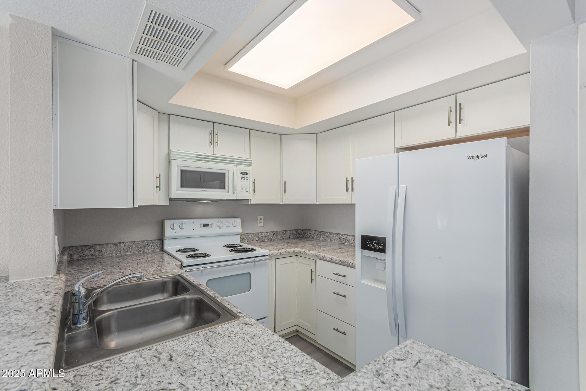 4730 West Northern Avenue, Unit 1087 Glendale, AZ 85301 - Photo 13 of 34 a kitchen with a sink a stove a refrigerator and cabinets