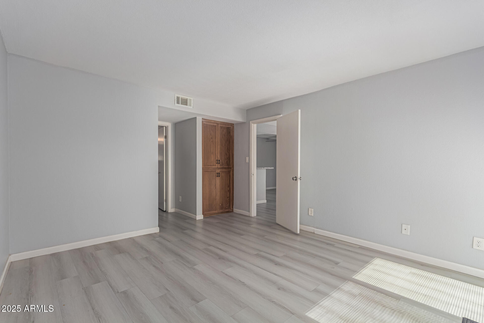 4730 West Northern Avenue, Unit 1087 Glendale, AZ 85301 - Photo 16 of 34 a view of an empty room with wooden floor