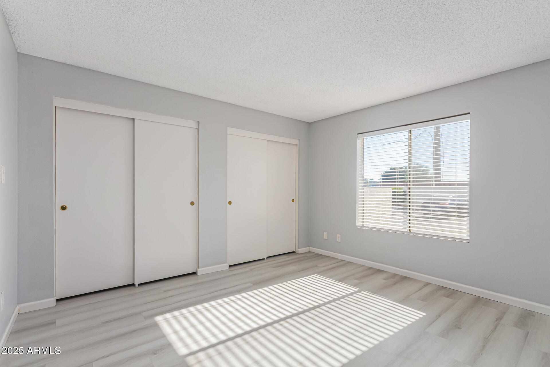 4730 West Northern Avenue, Unit 1087 Glendale, AZ 85301 - Photo 24 of 34 a view of an empty room with wooden floor and a window
