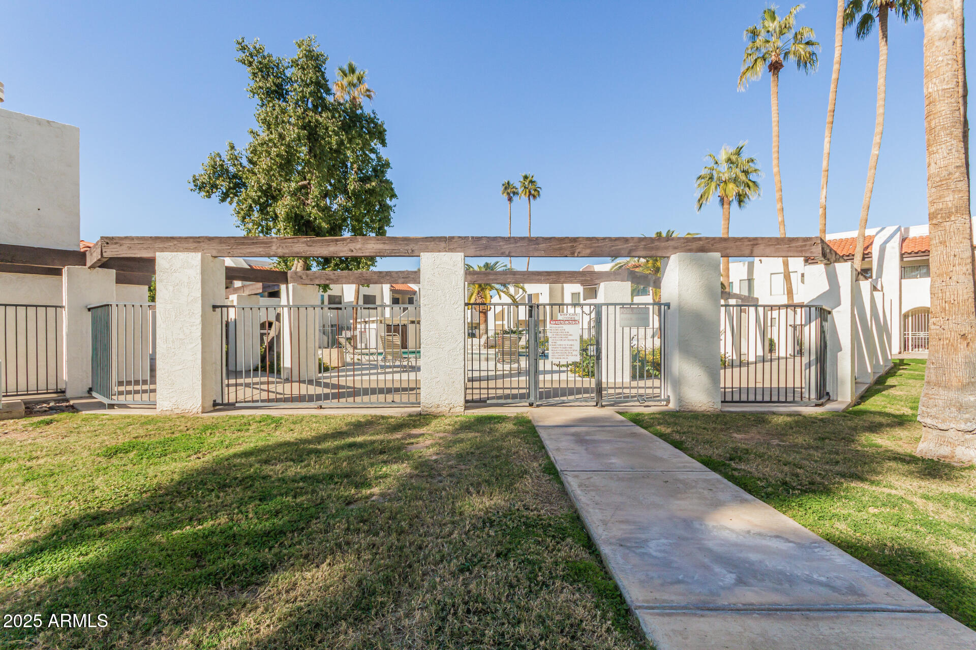 4730 West Northern Avenue, Unit 1087 Glendale, AZ 85301 - Photo 4 of 34 a spacious bedroom with a large window and a yard