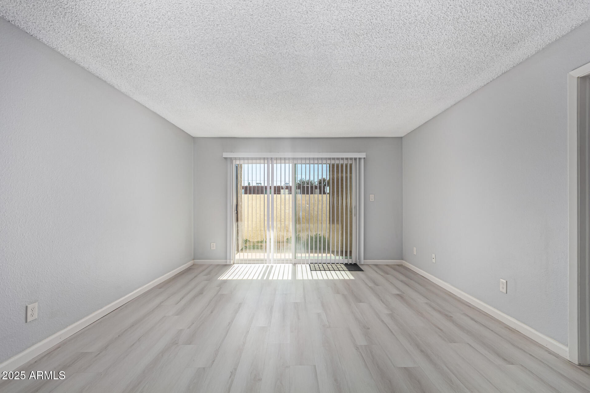 4730 West Northern Avenue, Unit 1087 Glendale, AZ 85301 - Photo 8 of 34 wooden floor in an empty room with a window