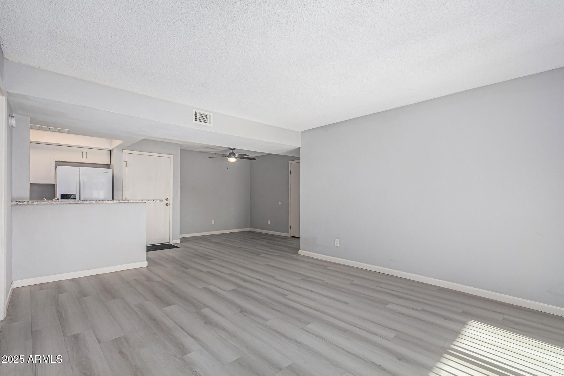 4730 West Northern Avenue, Unit 1087 Glendale, AZ 85301 - Photo 9 of 34 wooden floor in an empty room