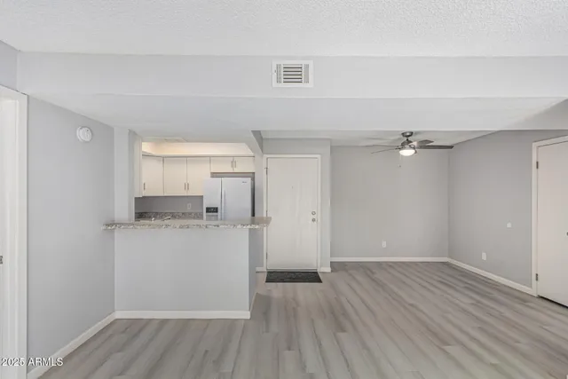 a kitchen with stainless steel appliances granite countertop a stove and a refrigerator
